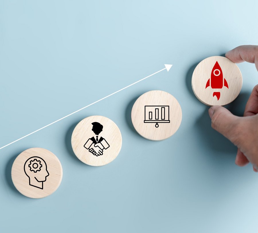 Holzsteine mit verschiedenen Pictogrammen, die für berufliches Vorwärtskommen stehen. Foto: Kiattisak/stock.adobe.com