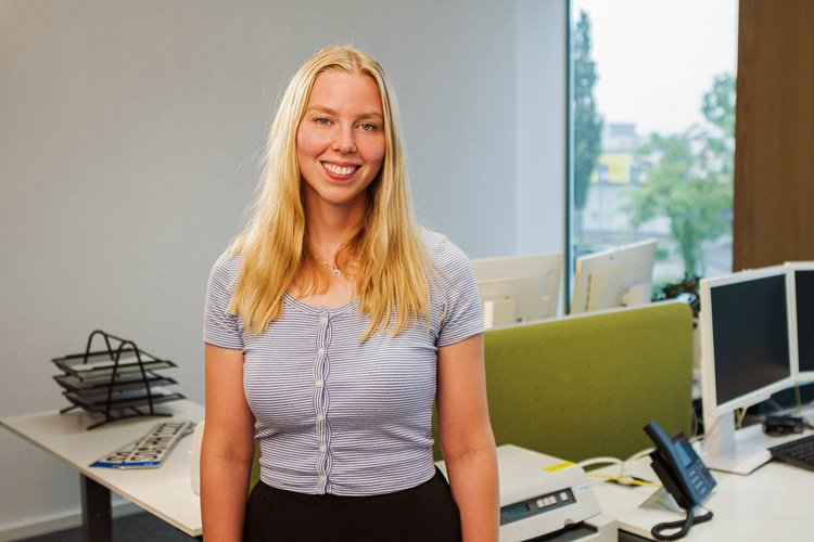 Eine junge Frau steht vor einem offen gestalteten Bürobereich. Foto: Thomas Grimm